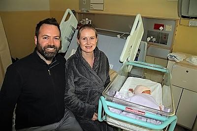 Man and woman with their baby born on New Year's Day