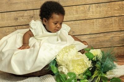 Baby Gail Shennan in basket next to white flowers for web