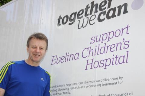 David Dean standing next to a 'support Evelina Children's Hospital sign